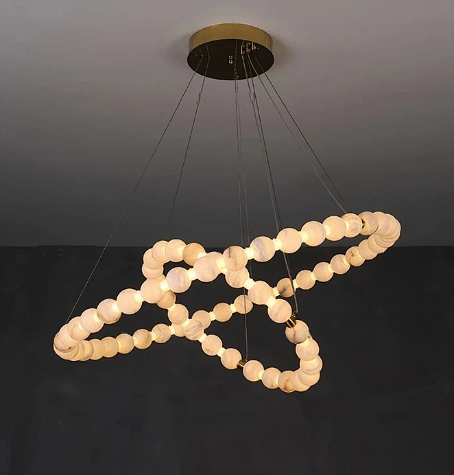 Sculptural alabaster globe chandelier with two interlocking rings and warm ambient light - L&B