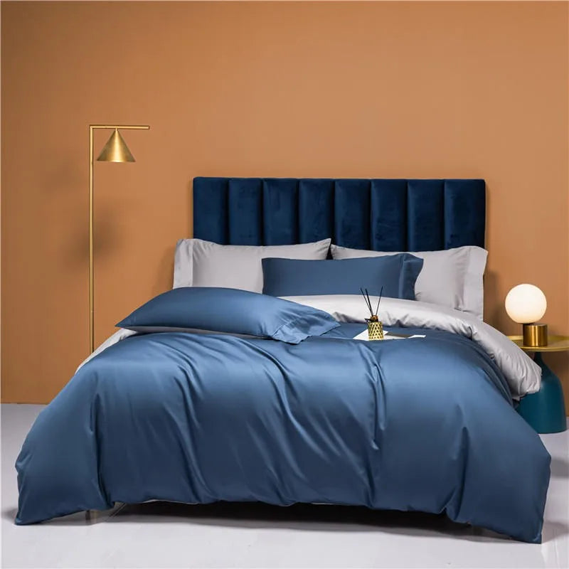 Modern bed styled with slate blue and silver gray reversible bedding, NESLLA BLUE GREY – L&B