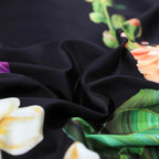 Close-up of smooth black Egyptian cotton fabric with vivid botanical flower detailing – L&B