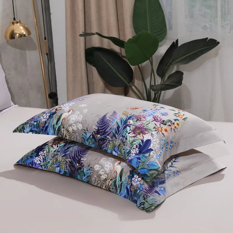 Stacked beige botanical pillow shams featuring colorful garden flowers and peacock details – L&B