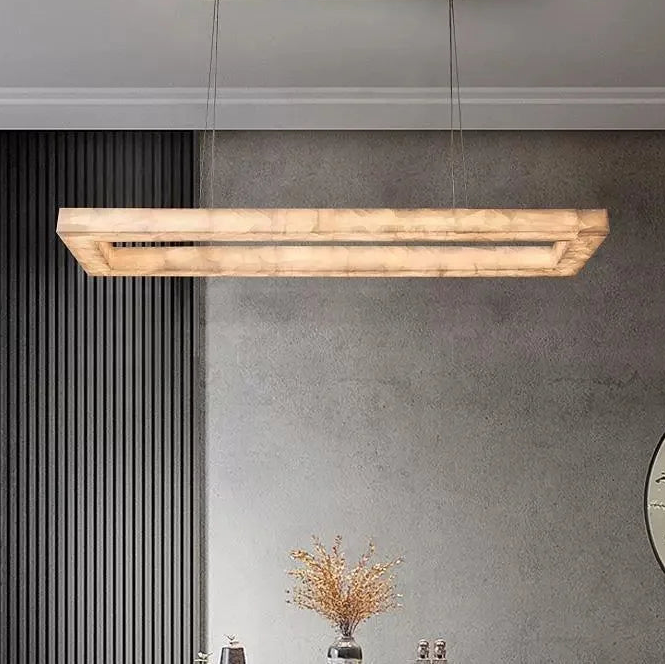 Modern alabaster linear chandelier with a rectangular frame and gold-finish ceiling canopy