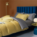 Golden yellow duvet cover layered with gray pillows in a warm contemporary bedroom – NESLLA YELLOW GREY – L&B