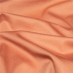 Close-up of smooth terracotta Egyptian cotton fabric with soft folds and a refined matte finish – NESLLA ORANGE BROWN – L&B