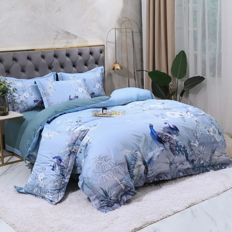 Chinoiserie peacock bedding with sky blue pillows and painterly blossom branches – L&B