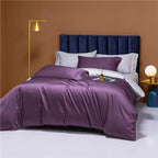 Deep purple bedding set styled with silver gray pillows and a navy upholstered headboard – NESLLA PURPLE GREY – L&B