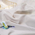 Close-up of smooth beige 600TC Egyptian cotton fabric with a softly flowing drape – L&B