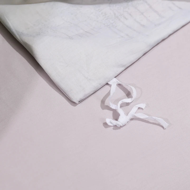 Interior corner tie detail on the soft lilac-gray reverse of the BEAUTIFLOWER duvet cover – L&B