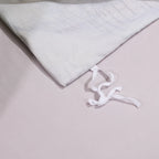 Interior corner tie detail on the soft lilac-gray reverse of the BEAUTIFLOWER duvet cover – L&B