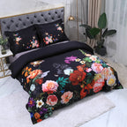 Black Egyptian cotton bedding styled with colorful garden flowers and coordinating floral pillow shams – L&B