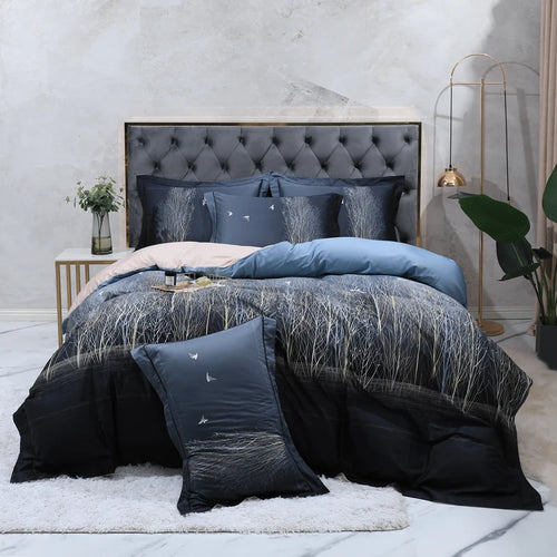 Navy blue forest bedding with misty white branches styled in a modern bedroom – L&B