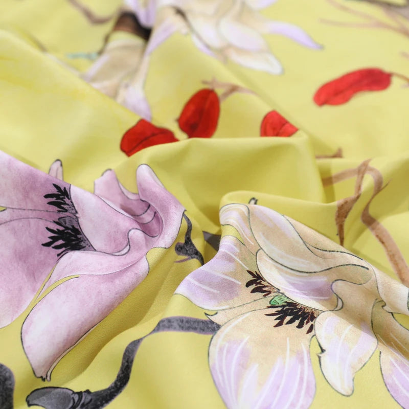 Close-up of watercolor blossoms and botanical details on the yellow Egyptian cotton duvet cover – L&B