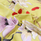 Close-up of watercolor blossoms and botanical details on the yellow Egyptian cotton duvet cover – L&B