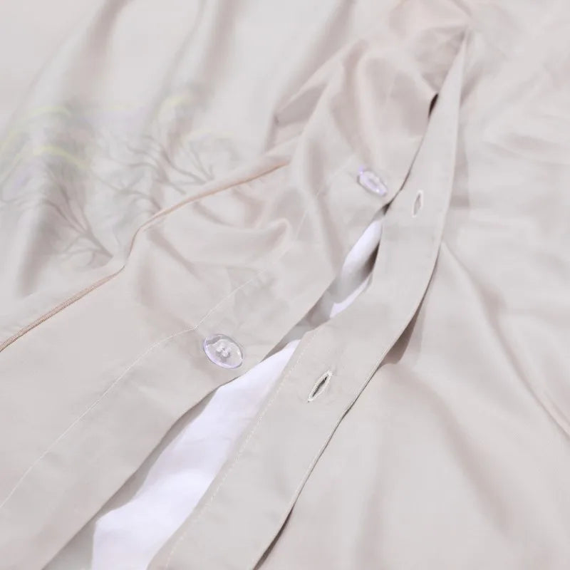 Button closure detail on the matching beige reverse of the FLIFLOWERS duvet cover – L&B