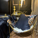 Black Egyptian cotton duvet cover draped to reveal colorful floral embroidery and gold scrollwork, PERIK – L&B