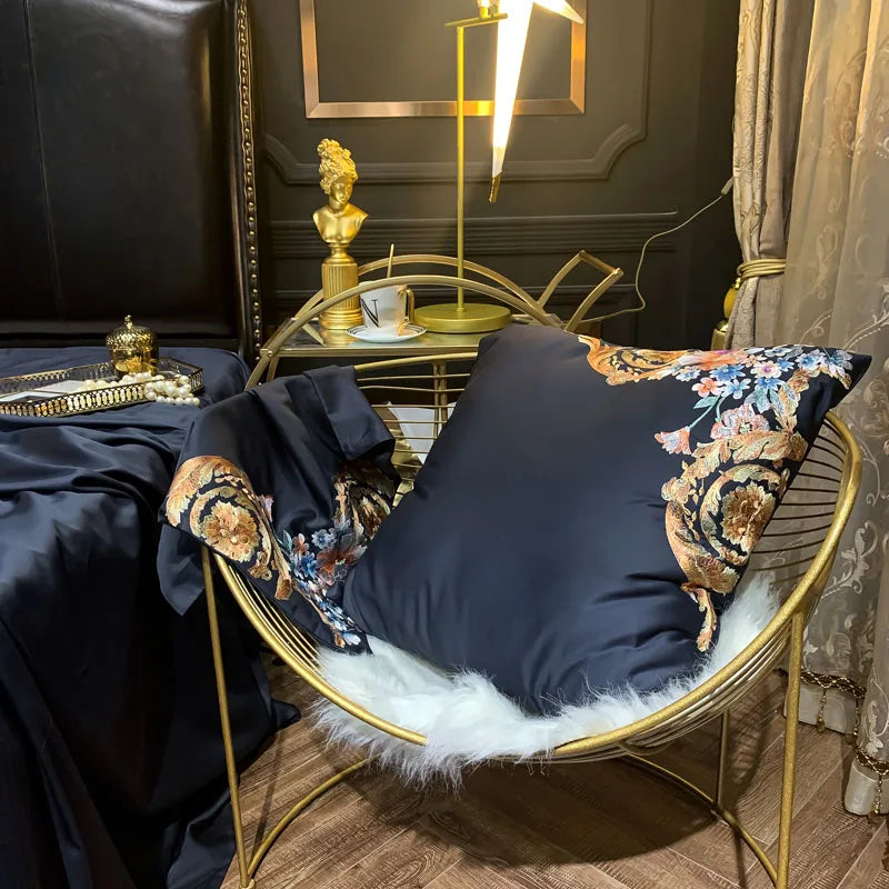Black Egyptian cotton duvet cover draped to reveal colorful floral embroidery and gold scrollwork, PERIK – L&B