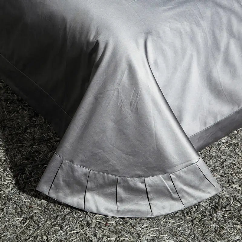 Coordinating pewter gray flat sheet with a decorative border and tailored drape, ZUTAPERA GREY – L&B