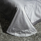 Coordinating pewter gray flat sheet with a decorative border and tailored drape, ZUTAPERA GREY – L&B