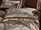 Close view of champagne gold embroidered duvet cover and coordinating pillow shams, SPECTO – L&B