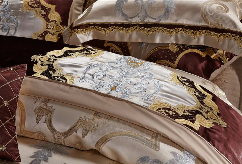 Layered champagne gold baroque pillows with rich wine red accents, SPECTO – L&B