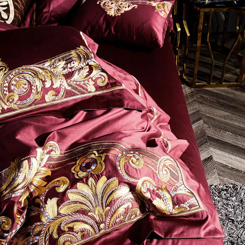 Close-up of gilded baroque scroll embroidery on a burgundy duvet cover, ZUTAPERA – L&B