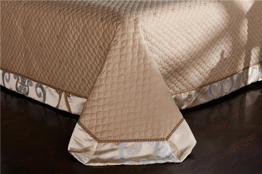 Champagne gold thick bed spread with a decorative embroidered border and tailored drape, SPECTO – L&B