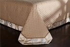 Champagne gold thick bed spread with a decorative embroidered border and tailored drape, SPECTO – L&B