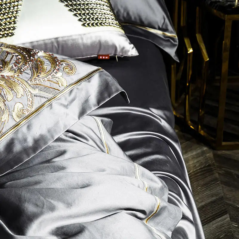 Pewter gray 1000TC Egyptian cotton bedding showing lustrous drape and gold embroidery, ZUTAPERA GREY – L&B