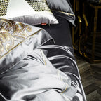 Pewter gray 1000TC Egyptian cotton bedding showing lustrous drape and gold embroidery, ZUTAPERA GREY – L&B