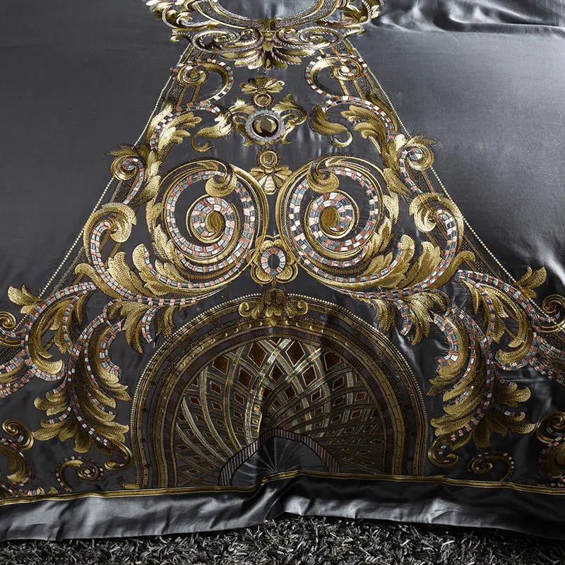 Close-up of ornate gold baroque medallion embroidery on pewter gray bedding, ZUTAPERA GREY – L&B