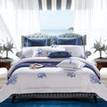 White and cobalt blue coral embroidered duvet cover set in a coastal bedroom – L&B