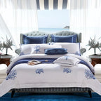 White and cobalt blue coral embroidered duvet cover set in a coastal bedroom – L&B