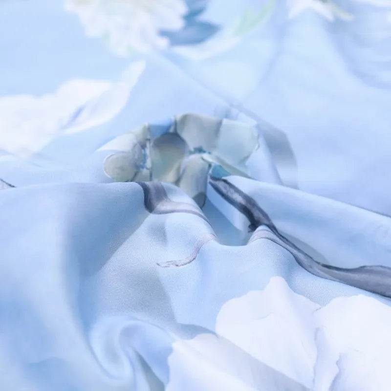 Close-up of smooth sky blue 600TC Egyptian cotton fabric with a softly flowing drape – L&B