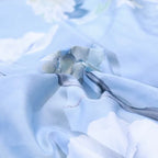 Close-up of smooth sky blue 600TC Egyptian cotton fabric with a softly flowing drape – L&B