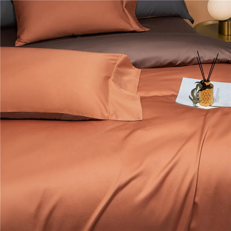 Terracotta Egyptian cotton pillowcases layered with deep brown shams on a reversible bedding set – NESLLA ORANGE BROWN – L&B