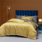 Golden yellow bedding set styled with soft gray pillow shams and a navy upholstered headboard – NESLLA YELLOW GREY – L&B
