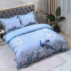 Sky blue Egyptian cotton bedding with peacocks and flowering branches in a modern bedroom – L&B