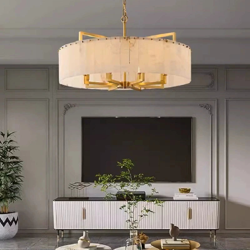 Alabaster drum chandelier with a gold frame in modern living room