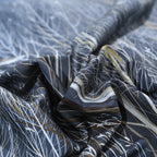 Close-up of the DARK FOREST duvet cover with white winter branches and flying bird details – L&B
