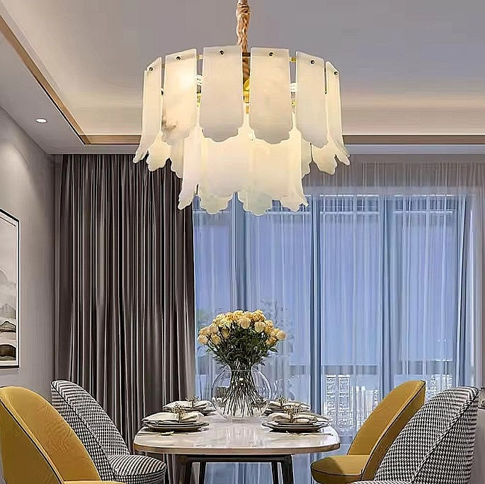 Modern 2-tier alabaster chandelier above a dining table in a warm contemporary dining room - L&B