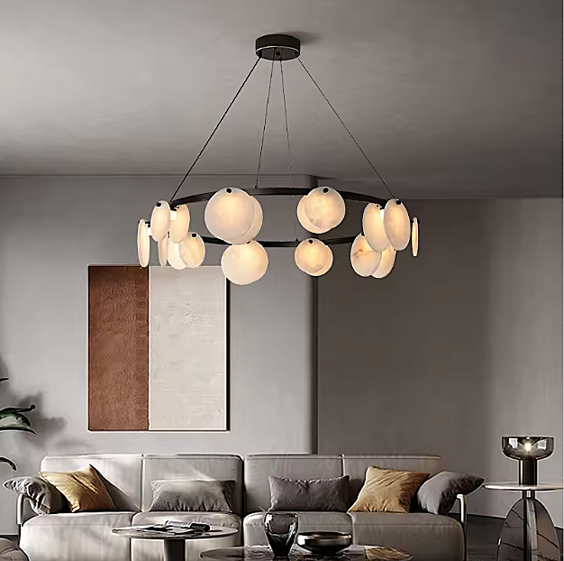 Sculptural alabaster disc chandelier above a sofa in a warm modern living room - L&B