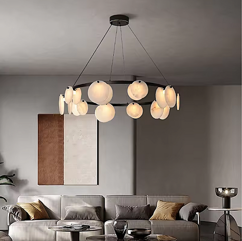 Sculptural alabaster disc chandelier above a sofa in a warm modern living room - L&B