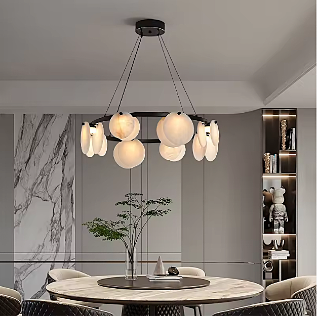 Alabaster disc ring chandelier above a round dining table in an organic modern dining room - L&B