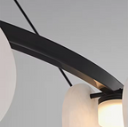 Black metal ring frame detail of a modern alabaster disc chandelier - L&B