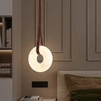 Bedside alabaster pendant light for a modern bedroom with a leather strap and soft ambient glow - L&B