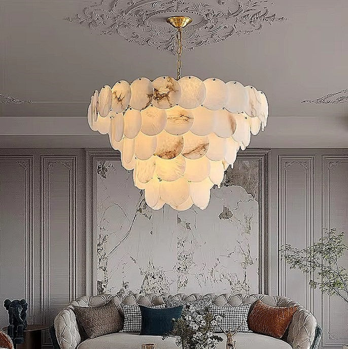 Large alabaster statement chandelier above a sofa in a modern classic living room - L&B