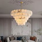 Large alabaster statement chandelier above a sofa in a modern classic living room - L&B