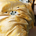 Close-up of a champagne gold jacquard duvet cover with fluid ornamental lines and a soft lustrous drape – L&B