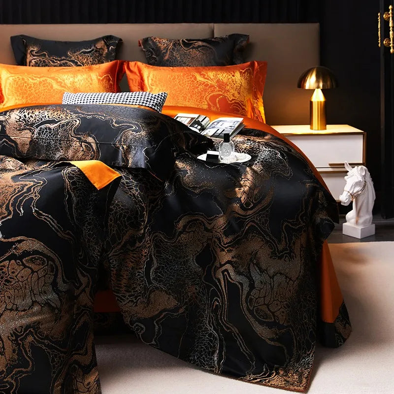 Luxury black jacquard bedding with metallic gold scrollwork, layered pillows, and an elegant flowing drape – L&B