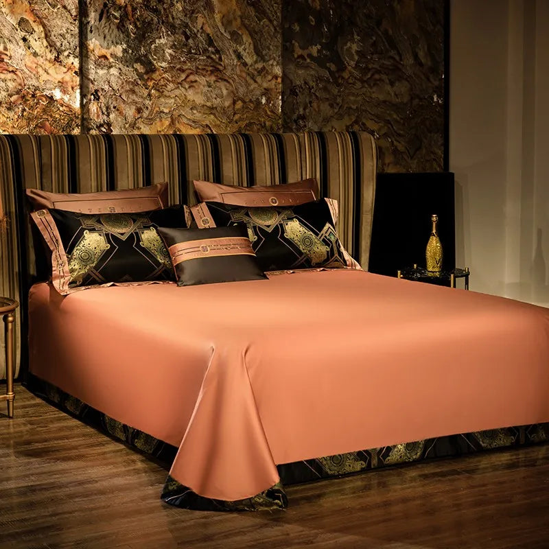 Solid copper-toned flat sheet with a smooth satin finish and coordinating black decorative pillows – ROYAL H. BLACK – L&B