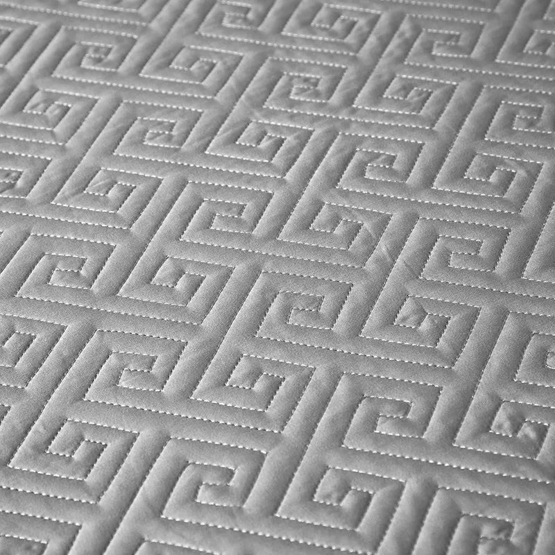 Close-up of silver gray geometric quilted bedspread texture from LUSTRA SILVER – L&B